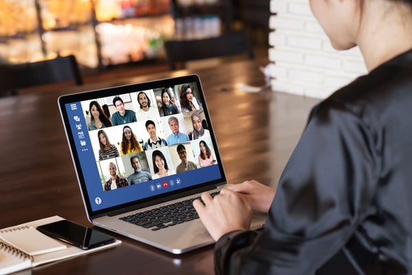 Individual on laptop participating in virtual call 